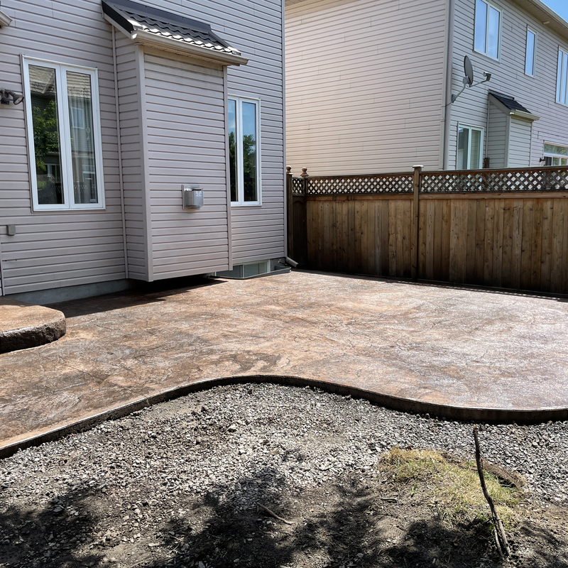 colored stamped back patio with stairs