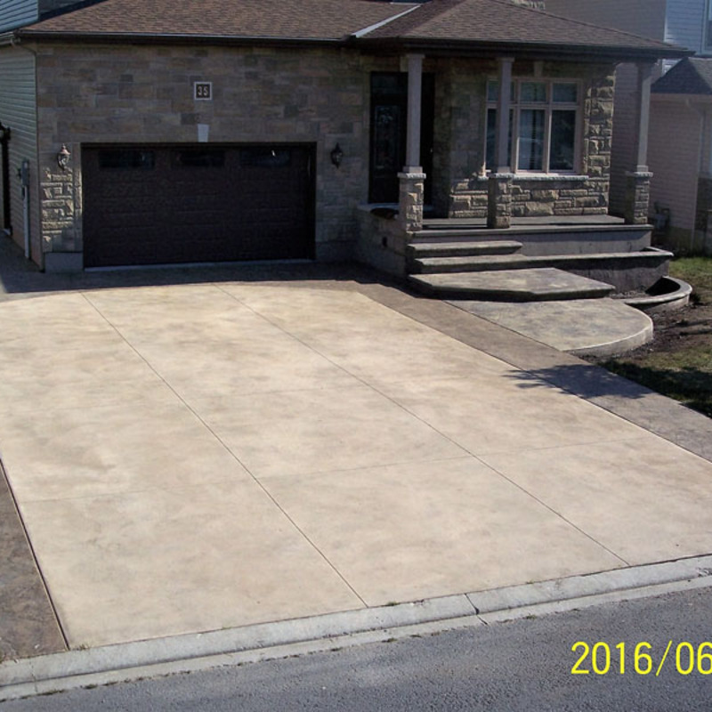 multi color stamped concrete driveway and front entrance with multiple stamp patterns