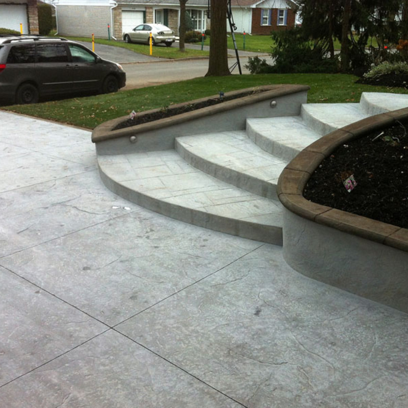 stamped concrete driveway and staircase with flowerboxes with stained bullnose caps