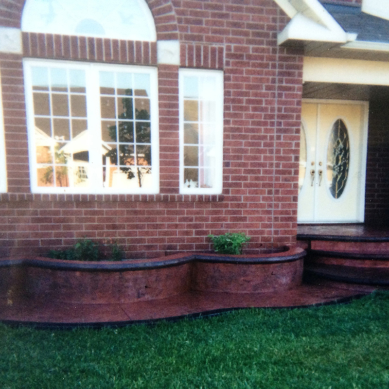 colored stamped concrete flowerboxes with bullnose caps